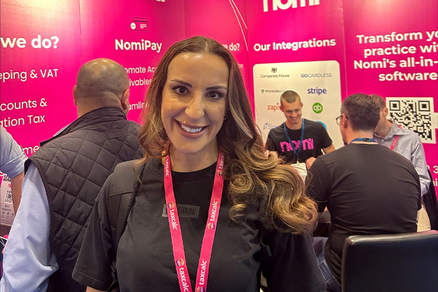 Francesca standing in front of Nomi booth at Accountex 2024